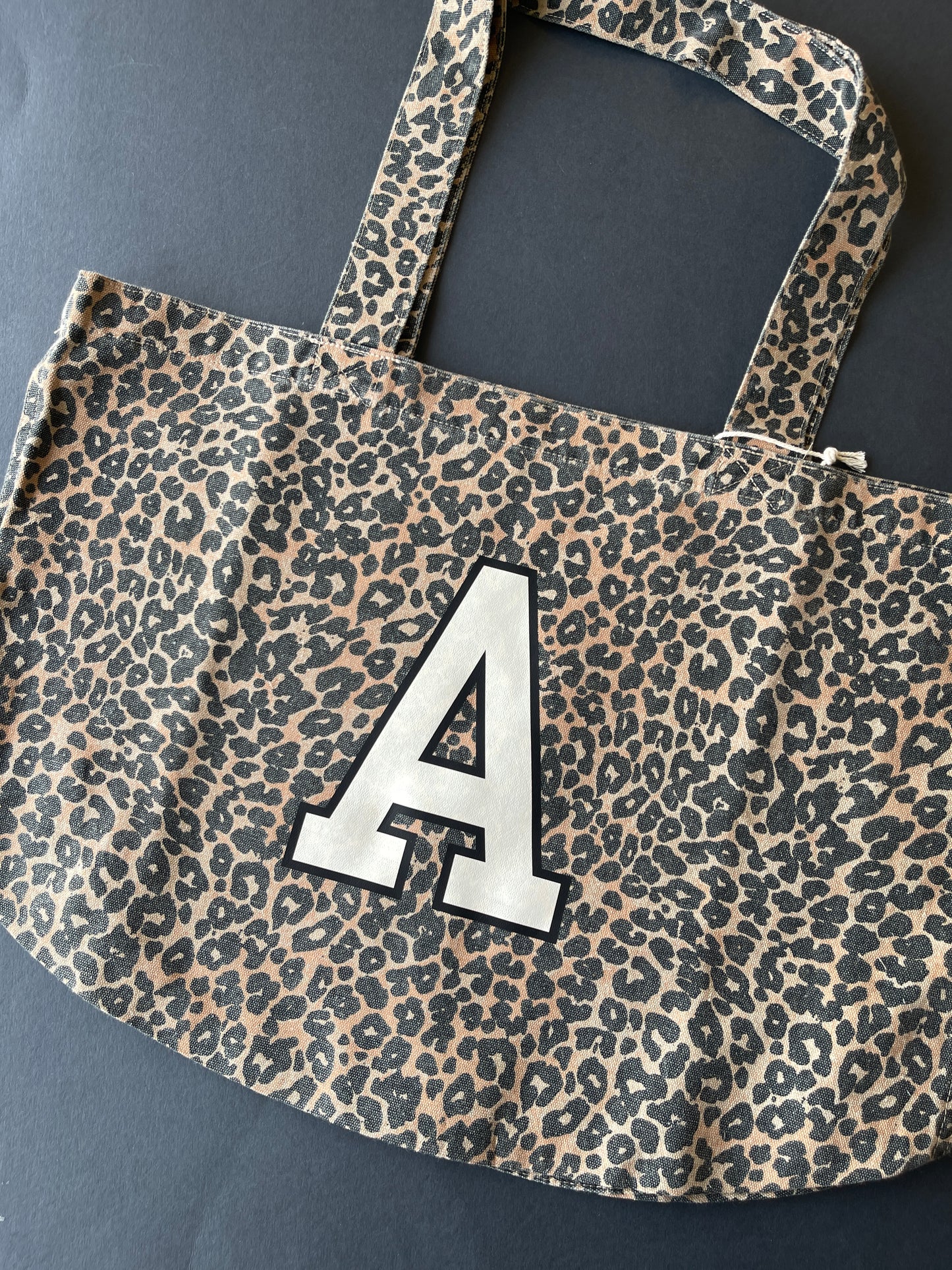 Leopard print tote bag with large A initial print in cream and black