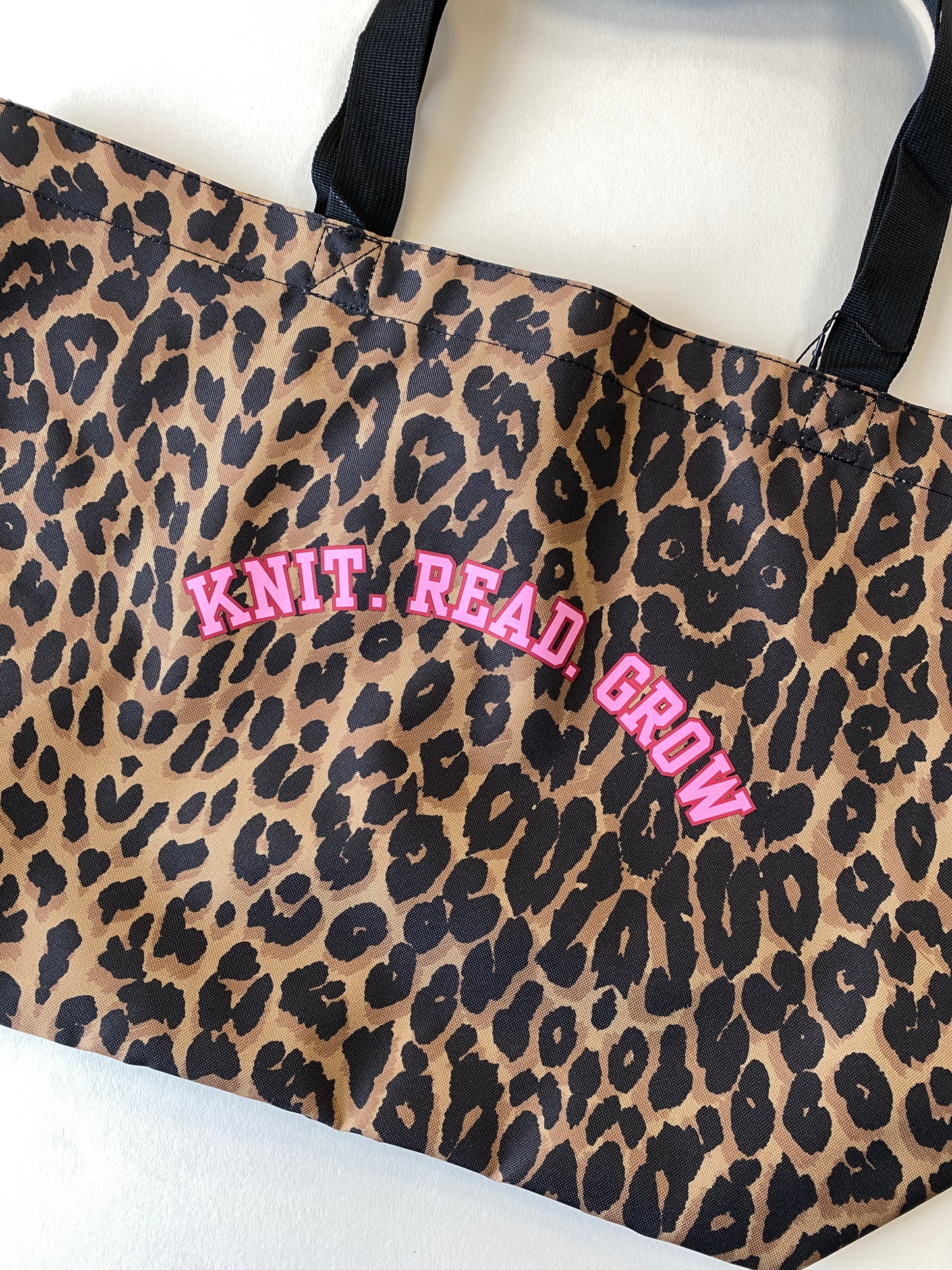 Leopard print tote bag with slogan 'Knit. Read. Grow' text in pink