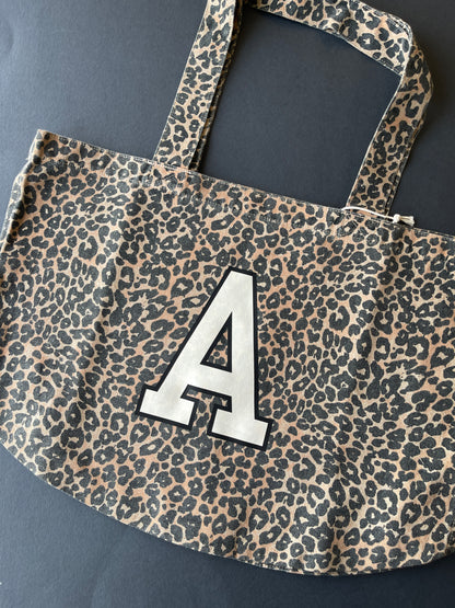 Leopard print tote bag with large A initial print in cream and black