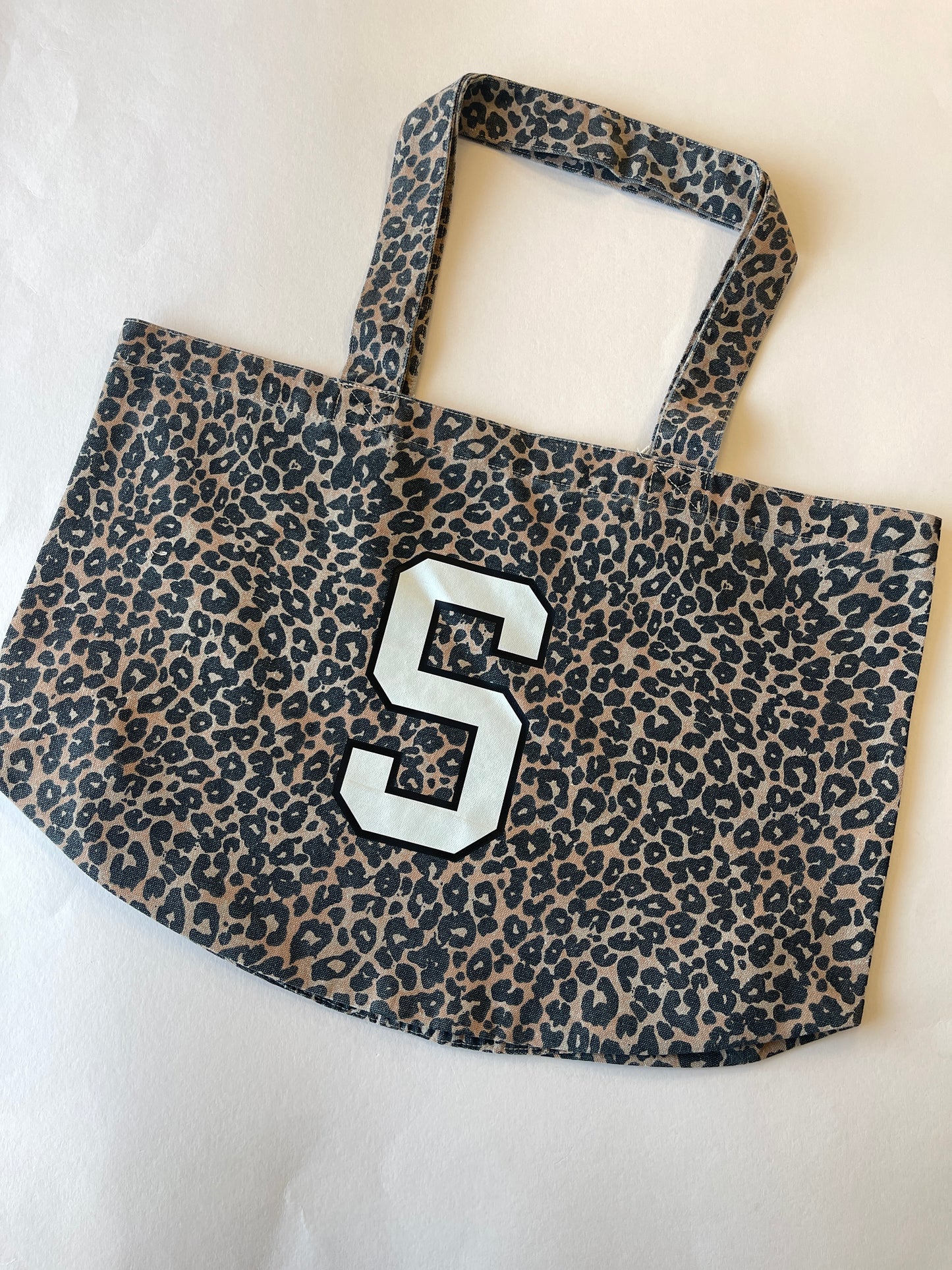 Leopard print tote bag with S initial printed in cream and black 