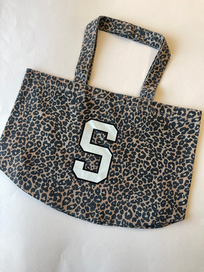 Leopard print tote bag with S initial printed in cream and black 