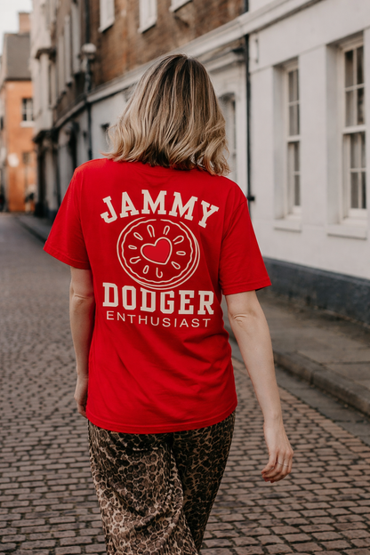 Person wearing a red t-shirt with 'JAMMY DOGDEER ENTHUSIAST' slogan design on the back