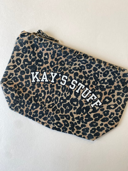 Leopard print pouch with 'KAY'S STUFF' text on a light background