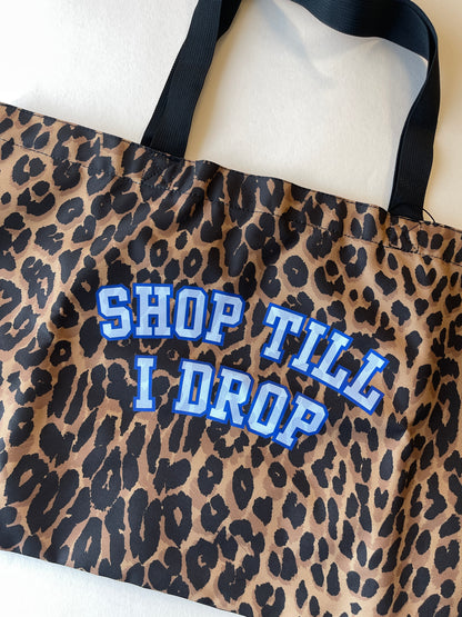 Leopard print shopping bag with 'SHOP TILL I DROP' text in blue