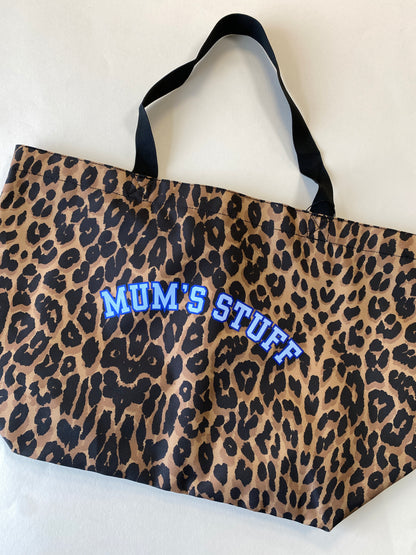 Leopard print bag with 'MUM'S STUFF' text in blue on a white background