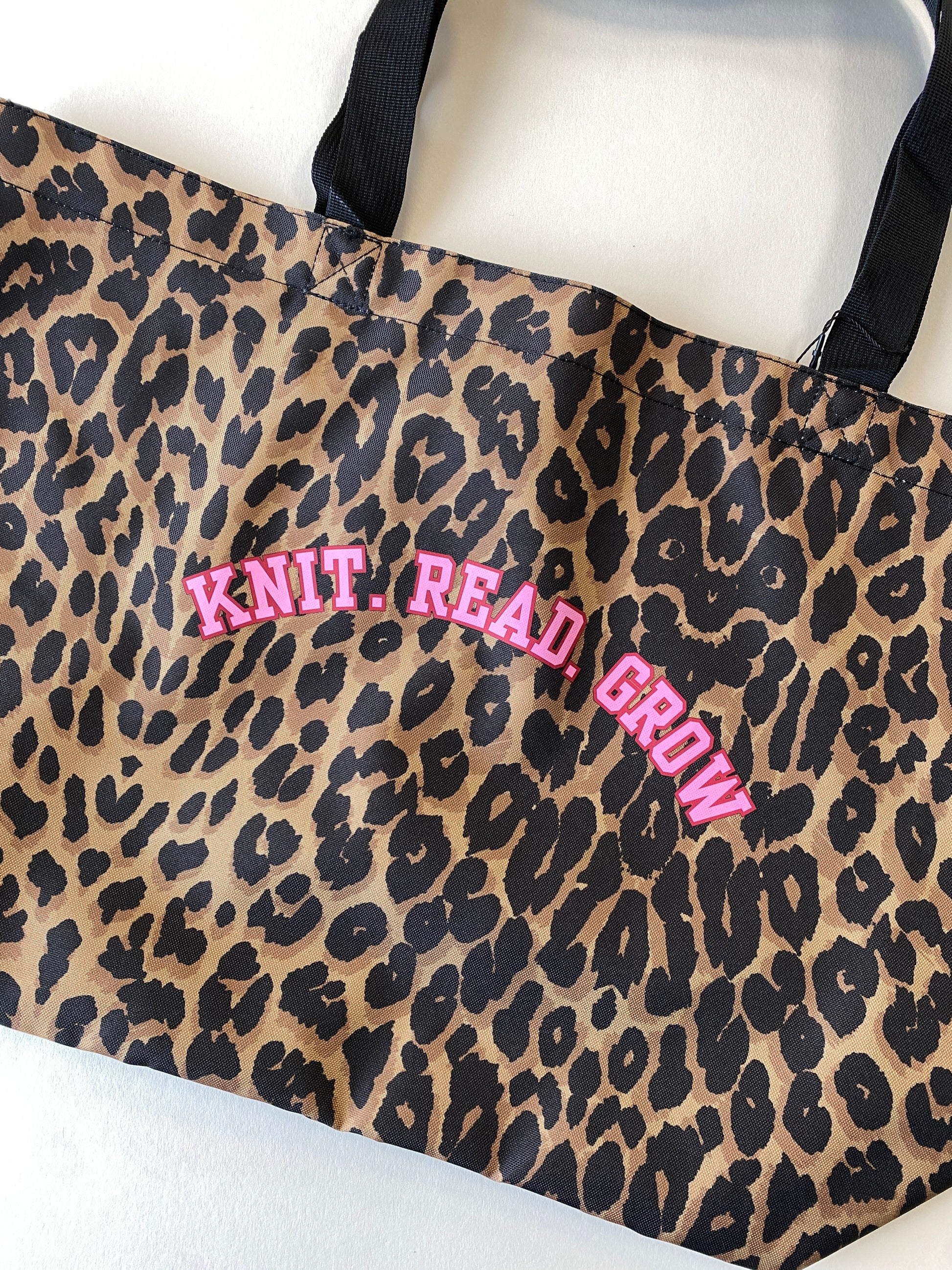 Leopard print tote bag with slogan 'Knit. Read. Grow' text in pink