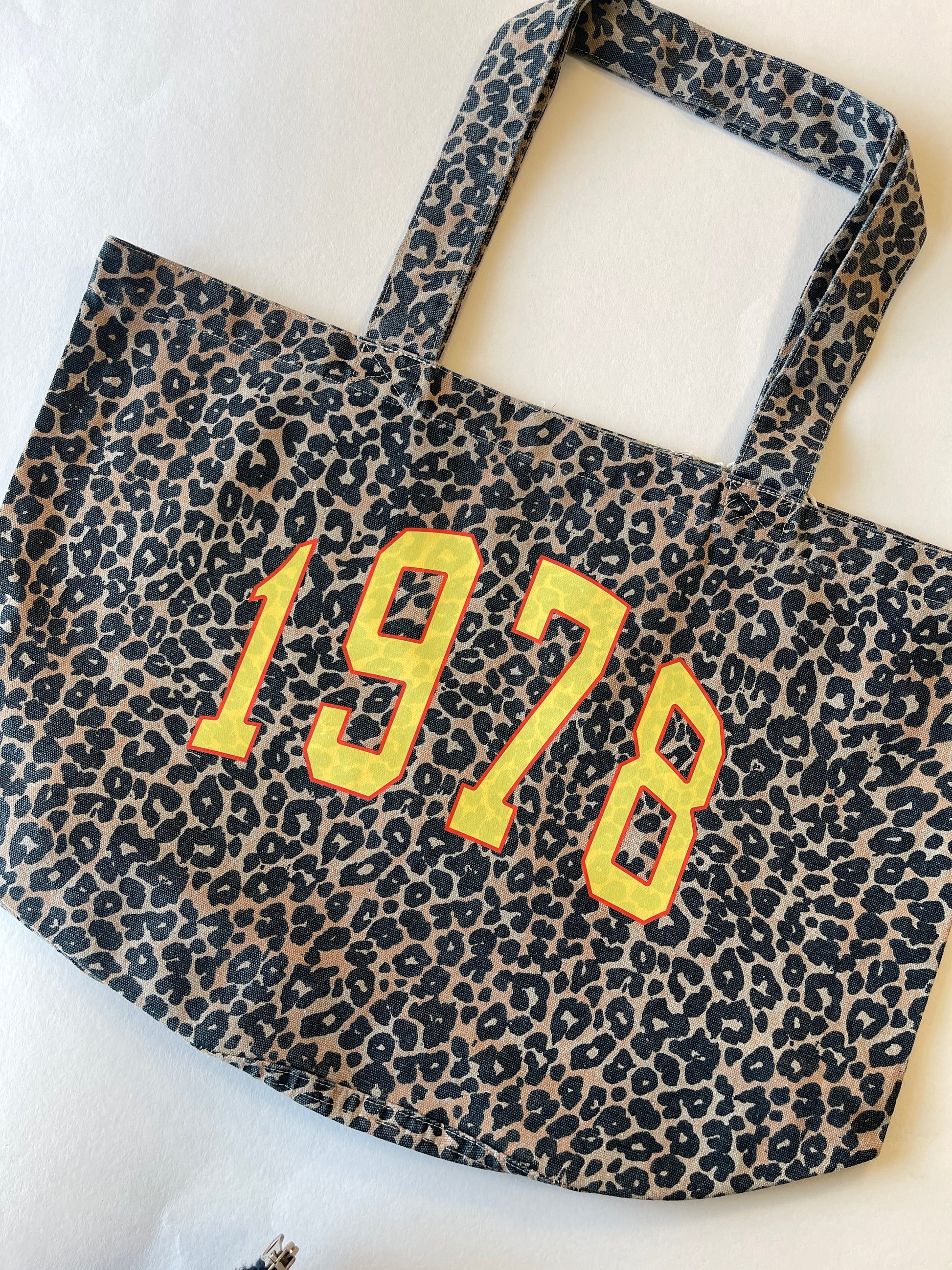 Leopard print bag with '1978' text on a white background