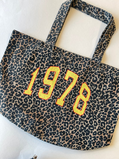 Leopard print bag with '1978' text on a white background