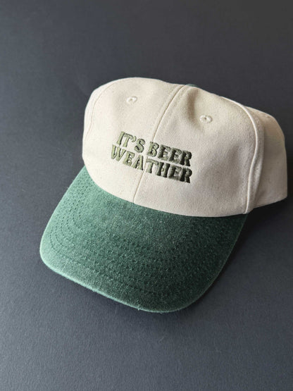 Cap in green and cream colour way with 'It's Beer Weather' text on a dark background