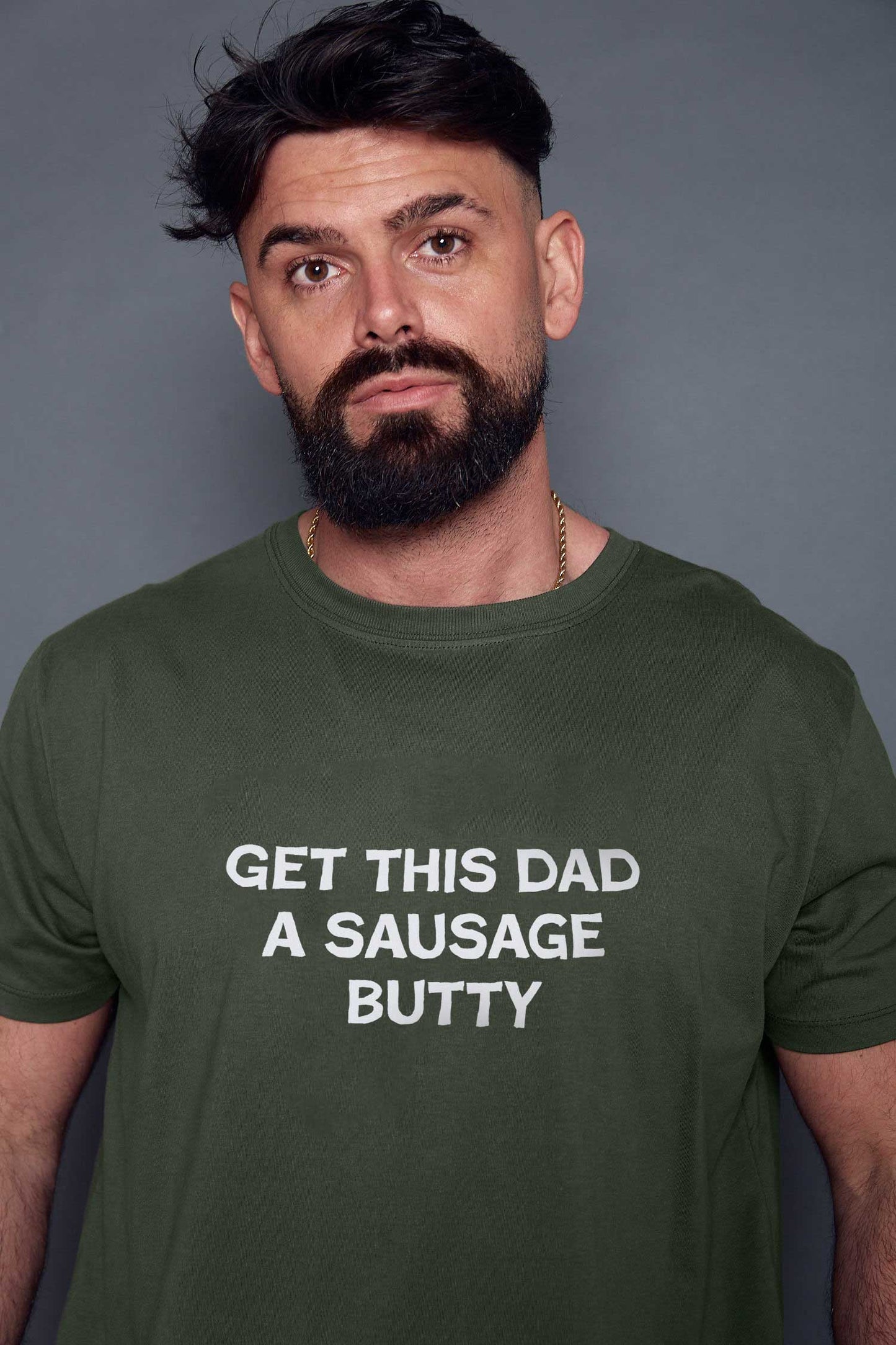 man wearing a khaki t-shirt with the white personalised text 'get this dad a sausage butty'