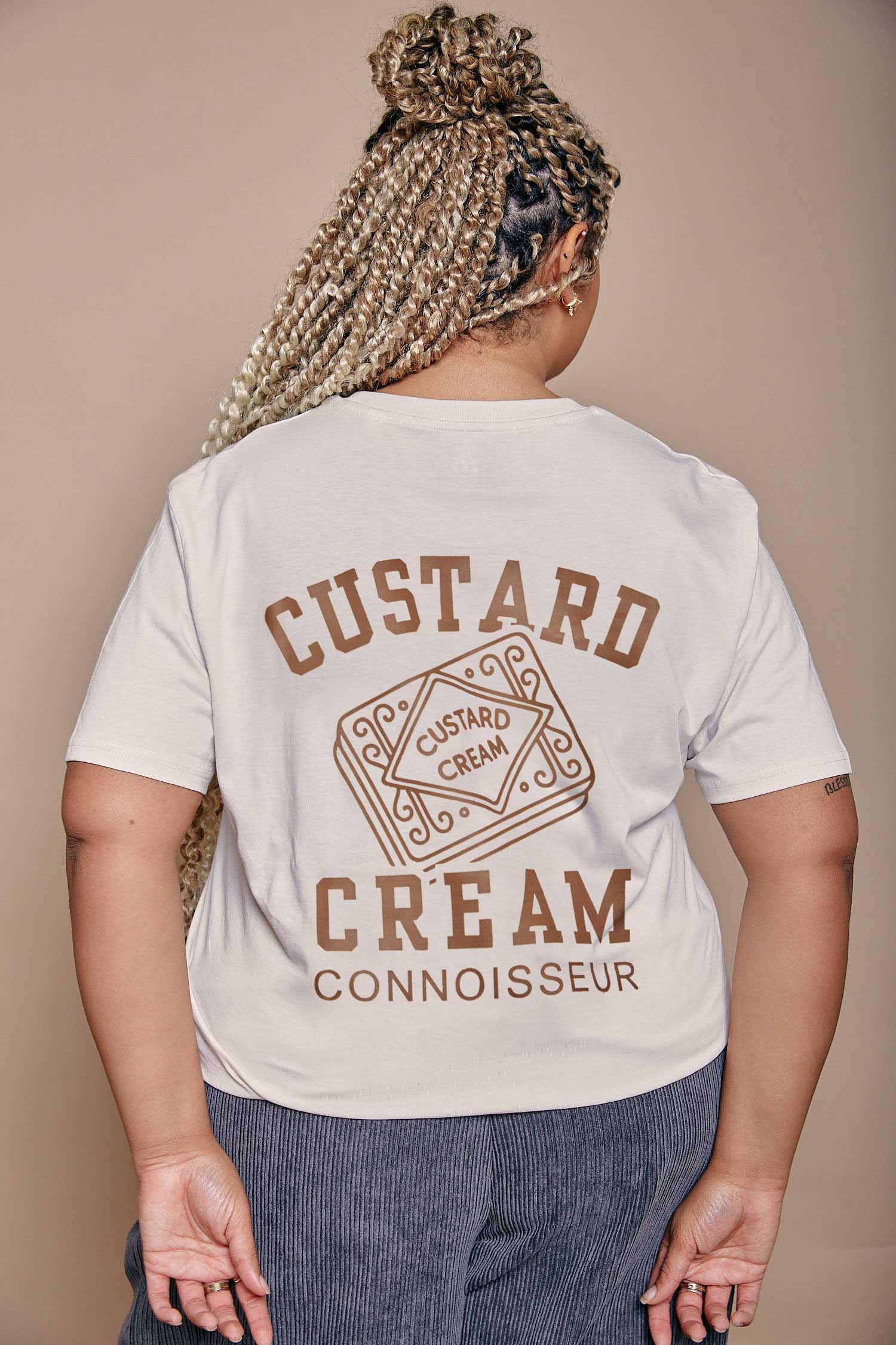 Person wearing a t-shirt with 'Custard Cream Connoisseur' text and graphics on the back.