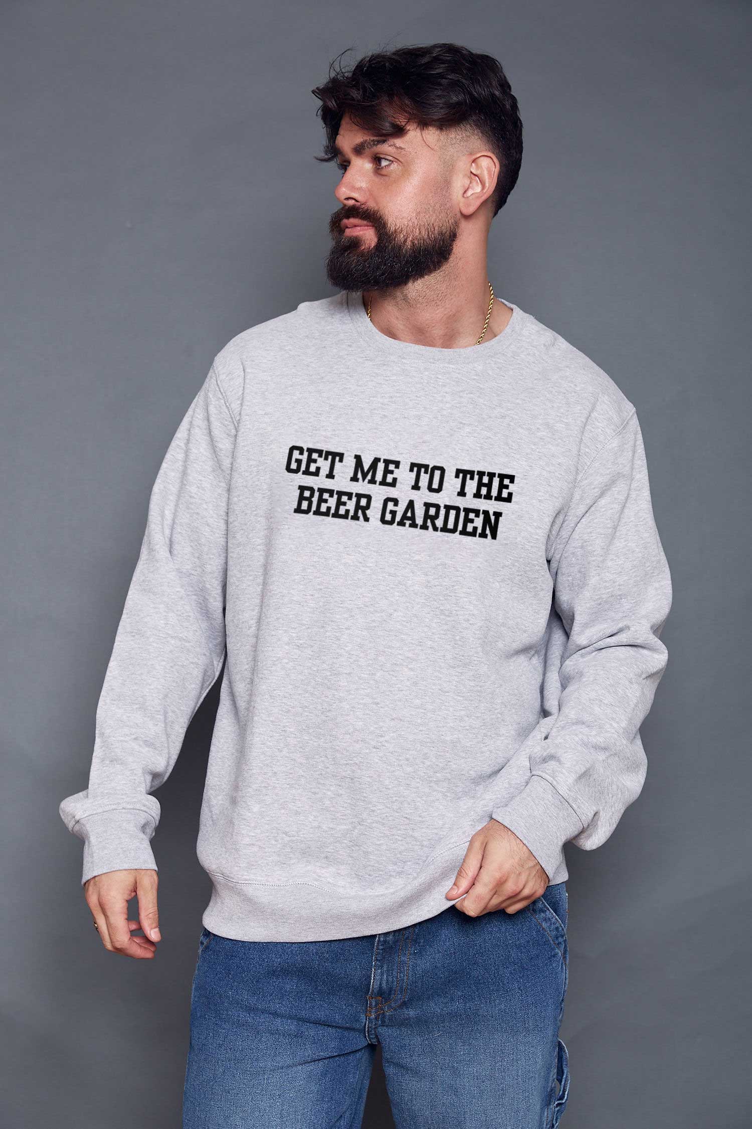 man wearing a grey sweatshirt with black slogan 'get me to the beer garden' in a varsity style font