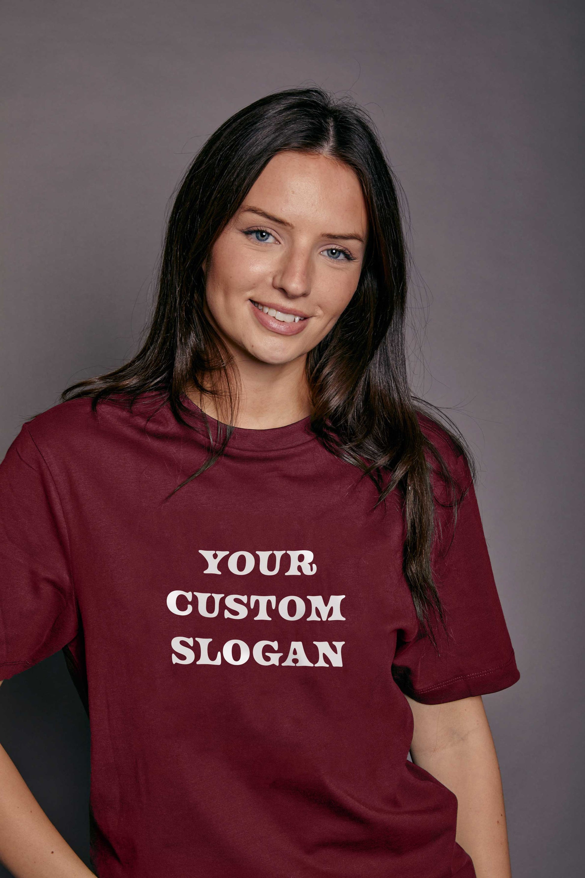 woman wearing a burgundy t shirt with the text 'your custom slogan' printed in white on the front
